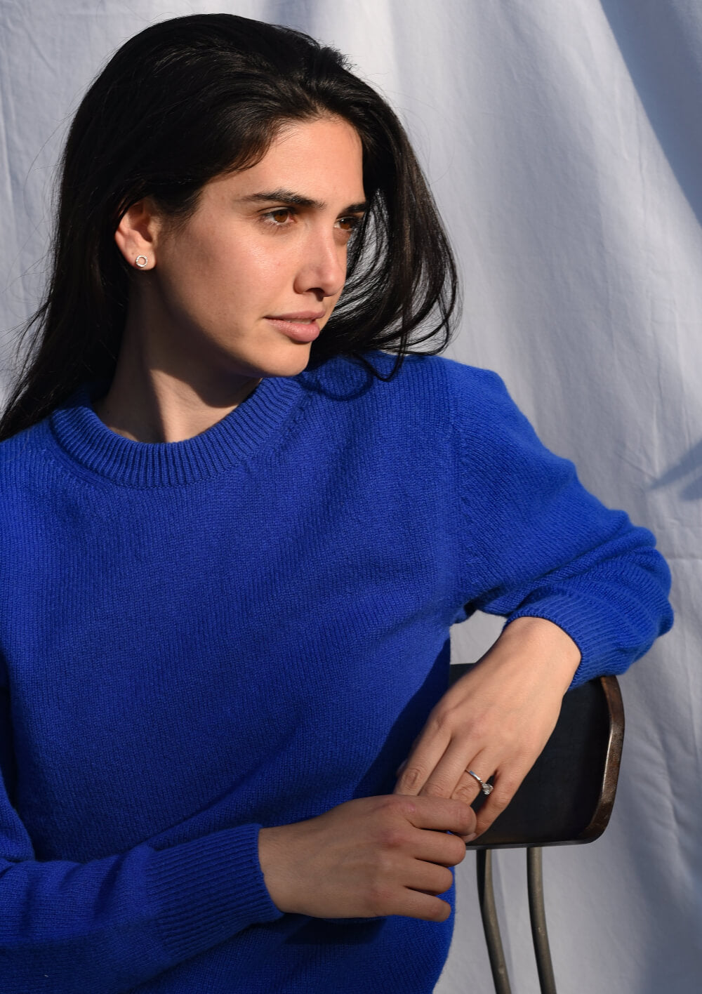 Woman wearing a blue crew neck jumper