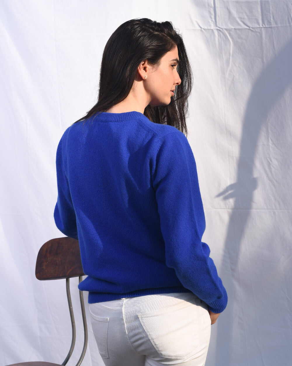 Woman wearing a blue knitted wool jumper